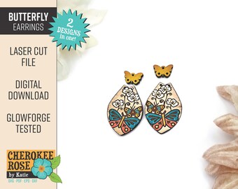 May include: Two laser cut wooden butterfly earrings with floral designs. The earrings are painted with blue, orange, and brown butterflies and white flowers. The earrings are on a white background.  2 Designs in one!