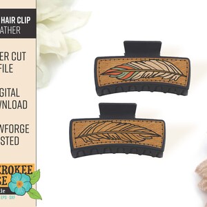 May include: Two black plastic hair clips with a wood-like finish. The top of each clip features a laser-cut design of a feather with brown, orange, and white details. The text "CHEROKEE ROSE" is visible in the bottom left corner of the image.