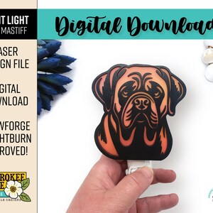 May include: A digital download file for a laser cut night light design of a Bull Mastiff dog. The design is in black and orange with a gradient effect. The image shows the night light lit up and held in a hand.