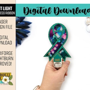 May include: A teal night light in the shape of an awareness ribbon, featuring a galaxy design. The night light is held by a hand. Text on the image includes "Night Light Awareness Ribbon," "Laser Design File," and "Digital Download."