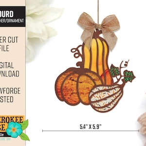 May include: A laser cut gourd suncatcher ornament with a rustic brown and orange colour scheme. The gourd is made up of three gourds, one with a patterned design. The ornament is 5.4 inches by 5.9 inches.