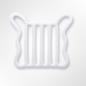 May include: White plastic cookie cutter shaped like a harp with seven strings.