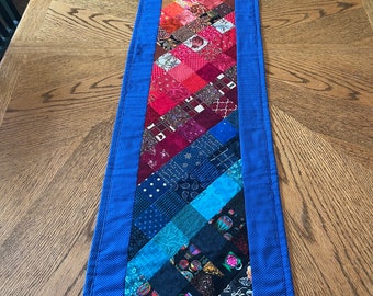 Quilted table runner, rainbow quilted table topper, colorful mosaic scrap quilt table runner with blue border and binding. 14”x56.5”