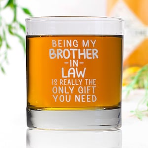 May include: A clear glass tumbler with the text "Being my brother-in-law is really the only gift you need" printed on the side. The tumbler is filled with a light amber liquid.