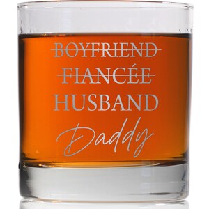 May include: A clear glass tumbler with the text "Boyfriend - Fianc&eacute;e - Husband - Daddy" etched on the side.
