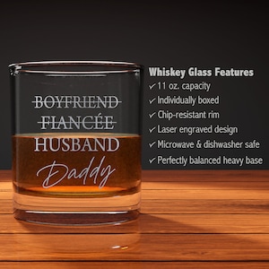 May include: A clear glass whiskey tumbler with the words "Boyfriend, Fianc&eacute;e, Husband, Daddy" etched on the side. The glass has an 11 ounce capacity and is individually boxed. It is chip-resistant, laser engraved, microwave and dishwasher safe, and has a perfectly balanced heavy base.