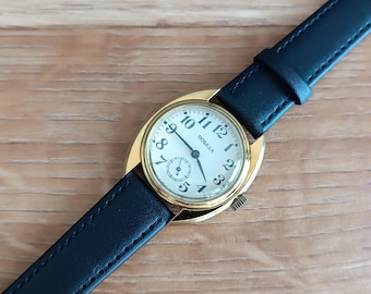 Vintage men's watch "Pobeda." Men's mechanical wristwatch in a yellow case. Classic men's watch with a round dial.