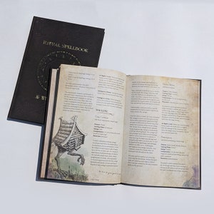 Op de afbeelding: Een open boek met een zwarte leren kaft. Het boek is getiteld "Ritual Spellbook". De pagina's staan vol met tekst en illustraties, waaronder een tekening van een huisje met poten. De tekst op de pagina bevat de spreuk "Cozy Cottage" en beschrijft de effecten van de spreuk.