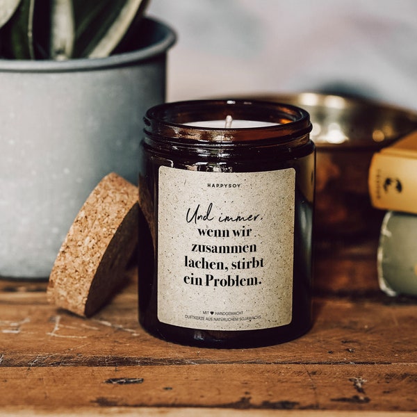 Scented candle with saying | And whenever we laugh together, a problem dies. | Soy wax candle in glass with cork lid
