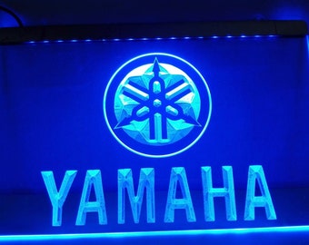 May include: Blue neon sign with the Yamaha logo and the word "YAMAHA" in white.