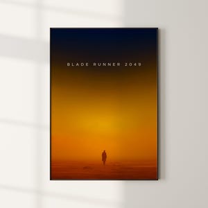May include: A minimalist poster with a black frame and a gradient background that transitions from dark blue to orange. The text "BLADE RUNNER 2049" is centered in white at the top of the poster. A silhouette of a person walking away from the viewer is in the center of the poster.