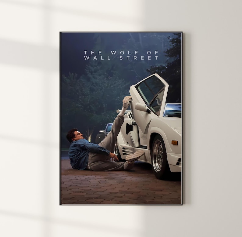 May include: A framed poster with the text "THE WOLF OF WALL STREET" at the top. The image depicts a white sports car with an open door and a person in a blue shirt and grey trousers. The scene is set outdoors.