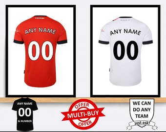 May include: Two soccer jerseys, one red and one white, with black trim and a black number "00" on the back. The jerseys are displayed on a shelf with a sign that says "ANY NAME & NUMBER" and a red and white sign that says "OFFER MULTI-BUY OFFER".