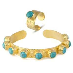 May include: A gold-toned bracelet and ring set with turquoise stones. The bracelet has a textured finish and features eight turquoise stones.