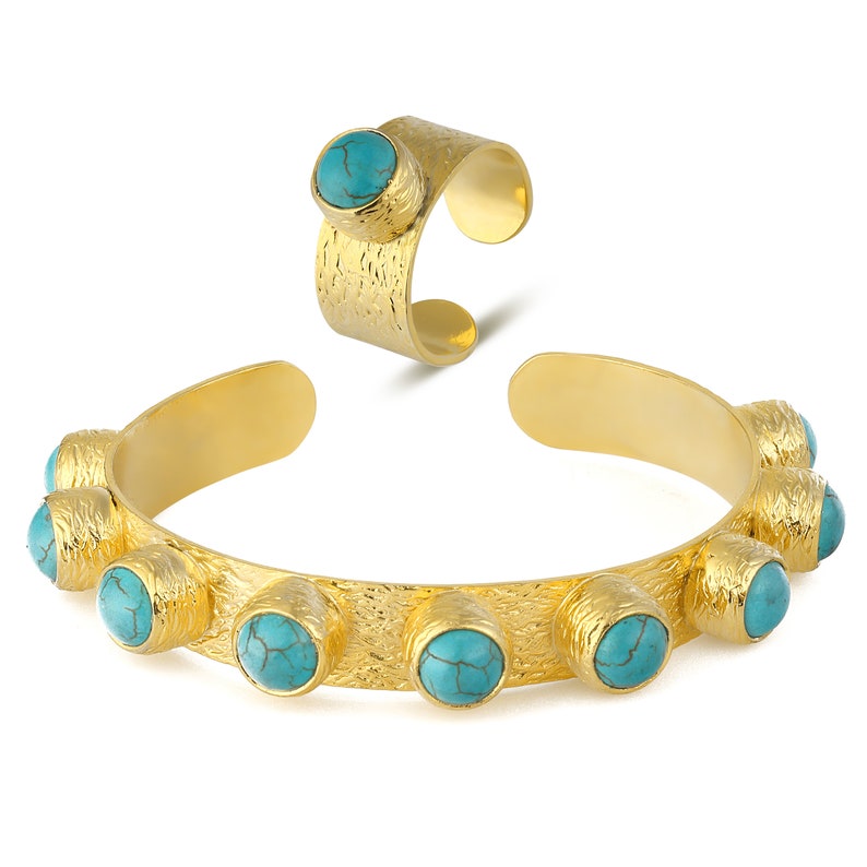 May include: A gold-toned bracelet and ring set with turquoise stones. The bracelet has a textured finish and features eight turquoise stones.