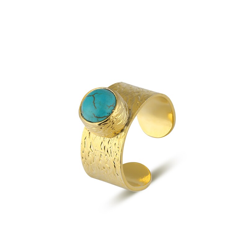 May include: A gold ring with a textured band and a turquoise gemstone.