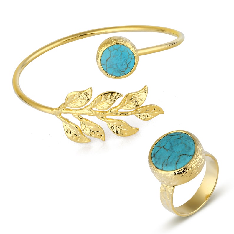 May include: A gold-tone ring and bracelet set with turquoise stones. The bracelet features a leaf design and the ring has a textured band.