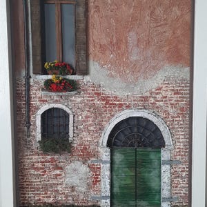 Three-dimensional miniature facade of a Venetian residential building with flower-filled balconies.
