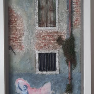 Pintura tridimensional de un ayuntamiento veneciano con un mural que representa "El niño migrante" de Banksy.