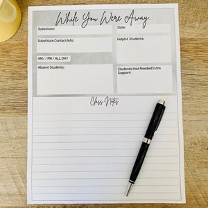May include: A white paper teacher substitute report form titled While You Were Away with sections for substitute name, date, contact info, helpful students, absent students, and extra support, plus a lined section for class notes and a black pen.