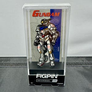 May include: A FigPin collectible of the Gundam ASW-G-08 Barbatos robot, displayed in a clear plastic case. The pin features a detailed design with white, gray, black, and gold accents. The case has the "Gundam" and "FigPin" logos.
