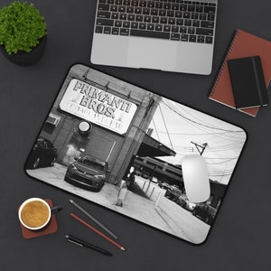 May include: Black and white photograph of a Primanti Bros. restaurant storefront with a car parked in front. The sign reads "Primanti Bros. Restaurant & Bar".