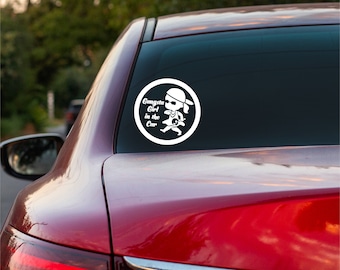 May include: White vinyl sticker with a cartoon girl wearing sunglasses and a bandana. The sticker says "Gangsta Girl in the Car" in a circle.