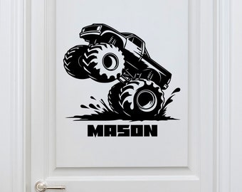 May include: Black and white silhouette of a monster truck with large tires, driving through mud. The truck is labeled with the name "MASON".