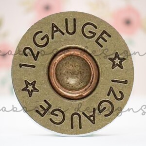 May include: A bronze-colored 12-gauge shotgun shell casing. The words "12 GAUGE" are stamped around the outer edge, with a star symbol between the words. The center has a copper-colored primer.