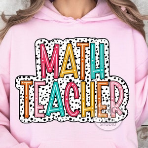 May include: Pink hoodie with a colorful graphic that says "MATH TEACHER" in a black and white polka dot pattern.