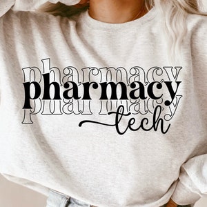 May include: A white sweatshirt with the text "pharmacy tech" printed in black. The text is stacked and appears to be in a retro style.