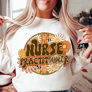 May include: White sweatshirt with a brown and orange graphic design that says "Nurse Practitioner" in a retro font. The graphic is surrounded by flowers and a leopard print circle.