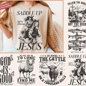May include: Beige t-shirt featuring a cowgirl on horseback, the words "SADDLE UP" and "JESUS". The design also includes the text "We're following". Other graphics include religious themes, fish, and a ram.