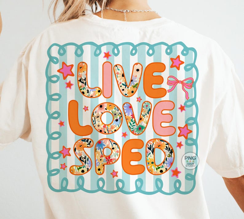 May include: White t-shirt with a colorful graphic on the back. The graphic says "LIVE LOVE SPED" in orange and pink letters, with floral patterns in some letters. The design is framed by a teal border with stars and a pink bow.