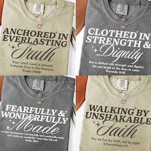 May include: Four Comfort Colors t-shirts with inspirational quotes and a delicate necklace. The shirts are in various colors: olive green, charcoal gray, and khaki. Each shirt features a different quote in white lettering, including Bible verses.