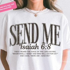 May include: White t-shirt with the words "SEND ME" in a distressed, dark brown font. Below, it reads "Isaiah 6:8" and a quote. The shirt is a solid color and has short sleeves.