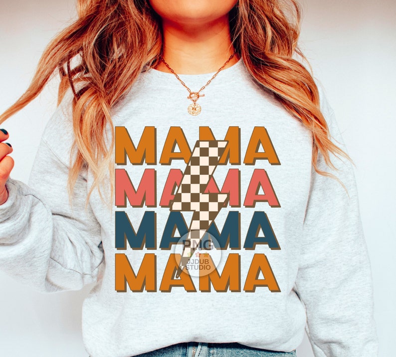 May include: A gray sweatshirt with the text "MAMA" repeated four times in different colors and a checkered lightning bolt graphic. The text is in a retro font style.