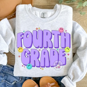 May include: A light grey sweatshirt with the text "FOURTH GRADE" in purple letters with a 3D effect. The letters are surrounded by colorful stars and smiley faces.