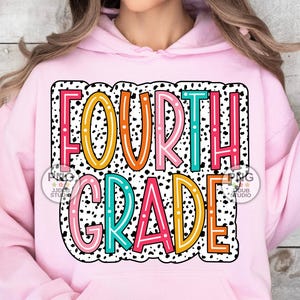 May include: Pink hoodie with a colorful graphic that says "FOURTH GRADE" in a black and white polka dot pattern.
