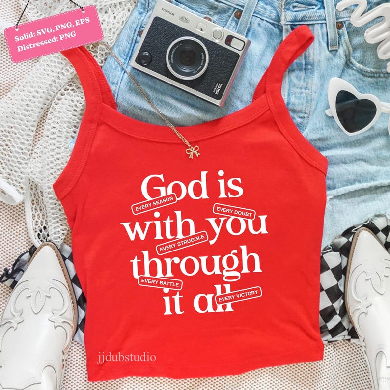 May include: A red tank top with the text "God is with you through it all" in white. The top is paired with denim shorts, a camera, sunglasses, and a necklace. The tank top has the words "Every Season, Every Doubt, Every Struggle, Every Battle, Every Victory".