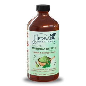 May include: A brown bottle with a black cap, labeled "Herbal Connections Organic Moringa Bitters Detox & Energy Liquid." The label features a green background with text and an illustration of a wooden bowl with green powder. The bottle contains 16 oz of liquid.