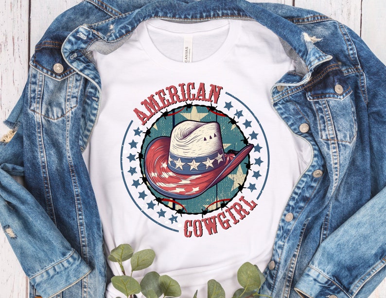 May include: White t-shirt with a red, white, and blue cowboy hat graphic. The graphic has a circle of stars around it and the text "AMERICAN COWGIRL".
