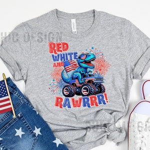 May include: A gray t-shirt with a red, white, and blue dinosaur monster truck design. The text "Red White and Rawrrr!" is printed on the shirt.