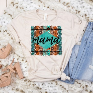 May include: A beige t-shirt with a turquoise and brown geometric design and the word "mama" in black text.