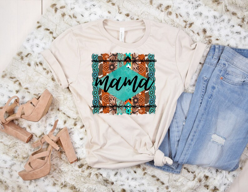 May include: A beige t-shirt with a turquoise and brown geometric design and the word "mama" in black text.