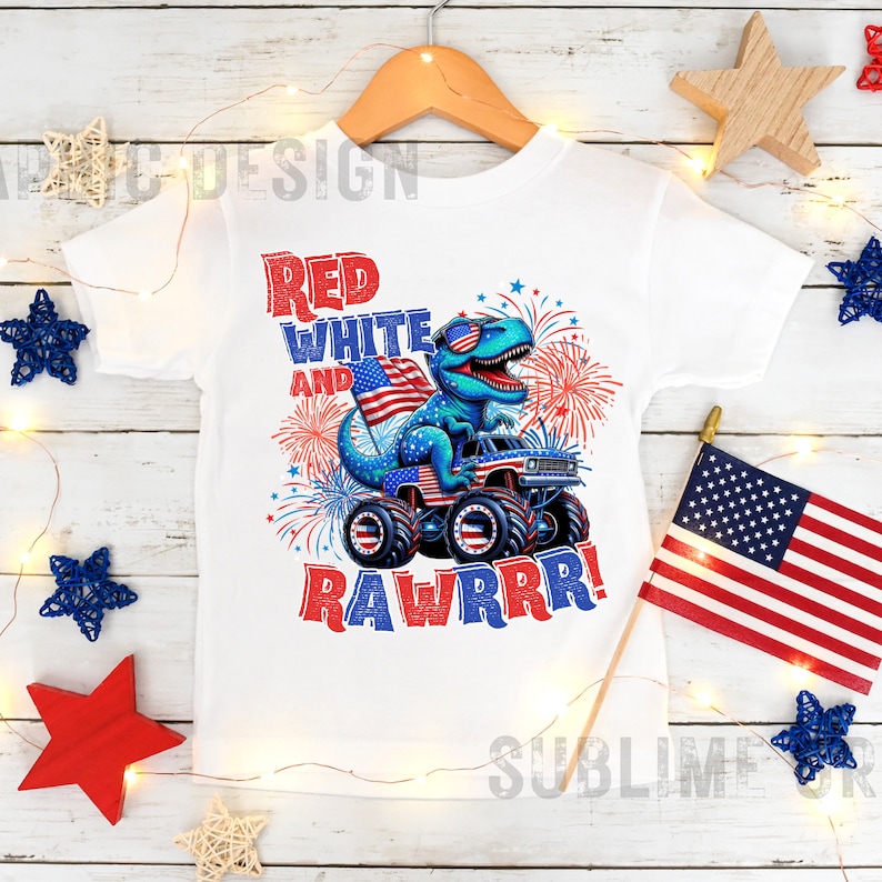 May include: White t-shirt with a blue dinosaur wearing sunglasses and driving a monster truck. The dinosaur is holding an American flag. The text on the shirt says "Red White and Rawrrr!"