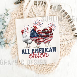 May include: Cream-colored tote bag featuring three rooster illustrations with fireworks. The central rooster is designed with an American flag pattern. The text "ALL AMERICAN chick" is printed in navy and red. The bag has cream-colored handles.
