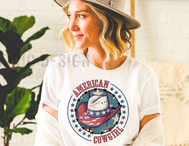 May include: White t-shirt with a red, white, and blue graphic of a cowboy hat with stars and the text "American Cowgirl".