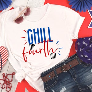 May include: White t-shirt with red, white, and blue text that says "Chill the Fourth Out". The shirt is laid out on a red, white, and blue background with a pair of sunglasses, a red and white striped flip-flop, and a blue and white star patterned scarf.