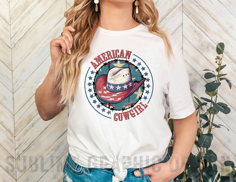 May include: White t-shirt with a red, white, and blue graphic of a cowboy hat with stars and the text "American Cowgirl".